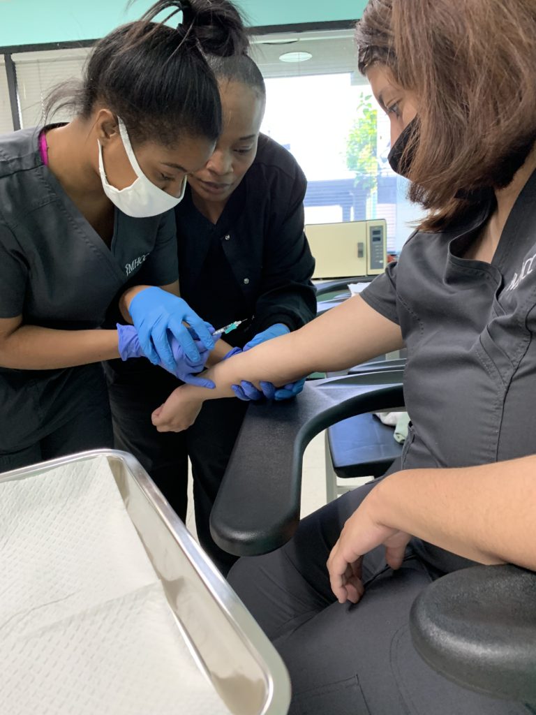 Medical Assistant practicing a blood draw