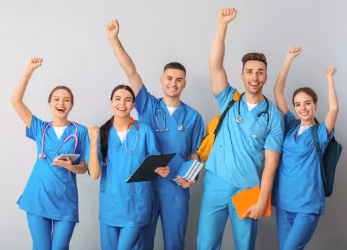 Group of five happy medical students on light background