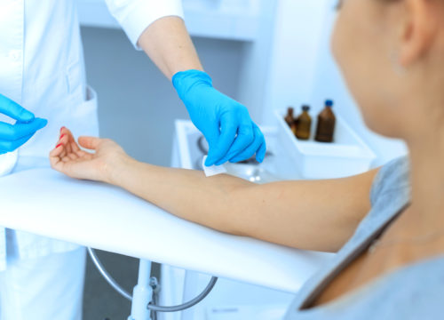 the nurse rubs the hand with alcohol before taking blood from a vein for testing. Disinfects the place of introduction of a needle with antiseptic.